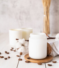 Beautiful burning candles with cotton flowers and coffee beans on white wooden background
