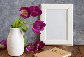 White poster frame mockup with  purple flowers in a vase