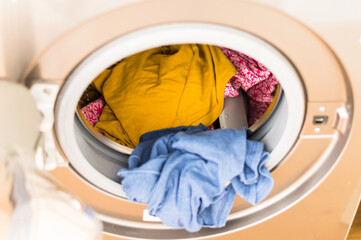 Laundry clothes inside a washing machine top down view