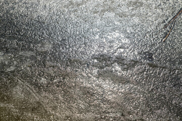 spring ice background with sun glare