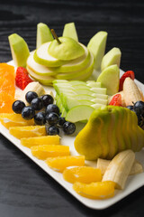Fruit plate, apples, pear, grape, orange and etc.