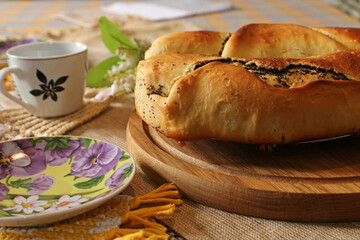  Homemade poppy seed pie on wooden table.