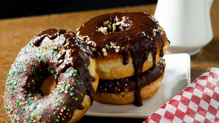 CHOCOLATE DONUTS WITH CHOCOLATE CHURROS ON TOP OF THE DONUTS
