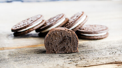 Chocolate cookies with creme filing on wooden background. food concept