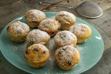 banana chocolate muffins on a blue plate which is on a wooden background. food concept