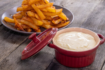 French fries with cheese sauce on wooden background. food concept
