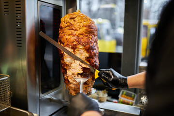 shawarma, lamb on a spit. street food. Doner Kebab on a rotating spit. A street food of Turkey....