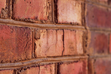Red brick wall sideways close up. Old textured surface background.