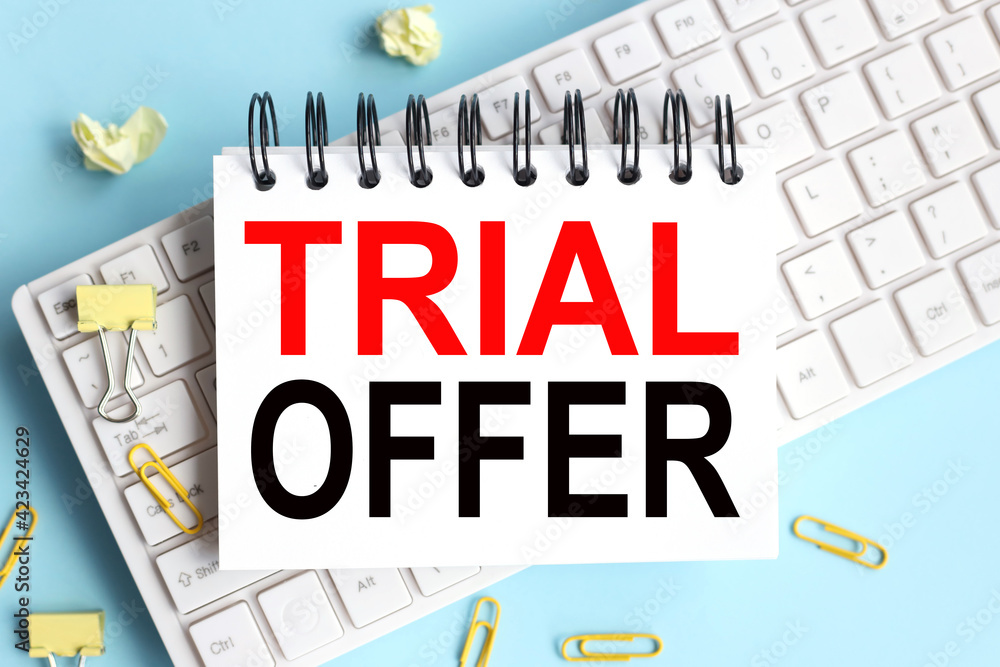 Poster trial offer. time to restart. text on white notepad paper on white keyboard
