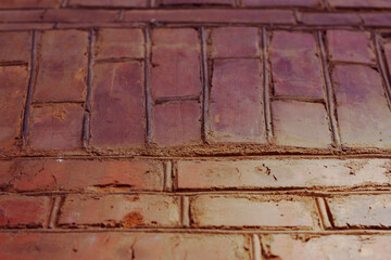 Colorful brick wall background angle view. Textured building surface.