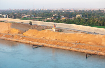 Suez Canal zone on the shore of Port of Suez, Egypt, Africa. Desert sand banks on the southern end of the Canal 