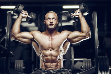Fototapeta na wymiar fit man training sholders muscles at gym.