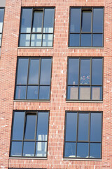 Fototapeta premium Closeup of a facade of brown bricks with window of a modern apartment