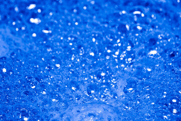 Naklejka na ściany i meble Blue foam. Foam texture as background. Background and texture concept. Close up of bubbling blue foam