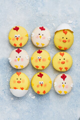 Easter macarons chicks on a blue background. Easter treat, dessert, symbol. Top view