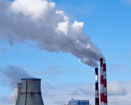 Smoke stack against the sky pollutes the air in industrial cities
