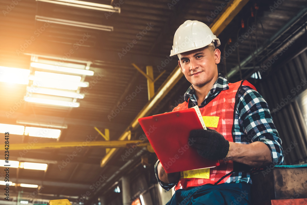 Poster manufacturing worker working with clipboard to do job procedure checklist . factory production line 