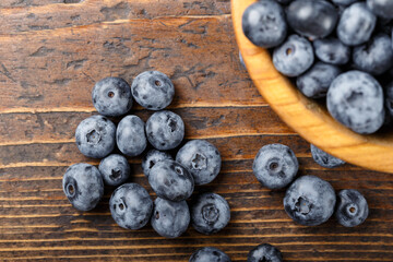 Fresh blueberries in a wooden bowl. Healthy and dietary food concept.