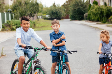 Kids have a leisure on bicycles outoodrs