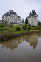 Fototapeta na wymiar mirror reflection of the old stone castle on the river of Verneuil sur Indre, France