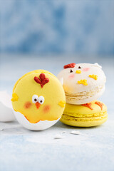 Easter macarons chicks on a blue background. Easter treat, dessert, symbol. Selective focus
