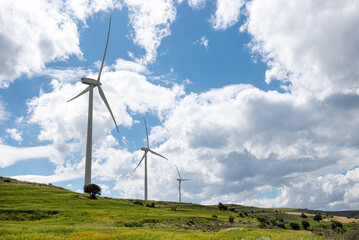 Windmills power generators on a turbine farm generating electricity from wind. Alternative...