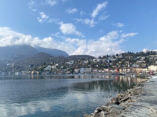Fototapeta premium View of the city of Ascona, Switzerland. View of the lake and mountains, sunny day. Beautiful landscape