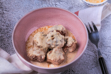 Homemade Swedish Meatballs coated in a gravy sauce served on a plate. 