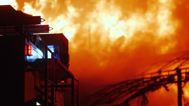 fire truck and flasher fire engine. fire on the roof of the house. a burning at building house night. home apartment insurance concept. huge fire blazes houses 911. property damage arson protection