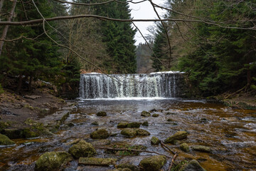 Cascade falls over mossy rocks