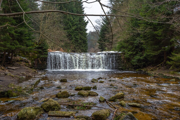 Cascade falls over mossy rocks