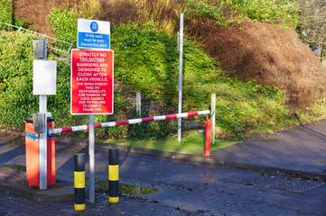 Fototapeta na wymiar Automatic barrier access control beware bollards and sign