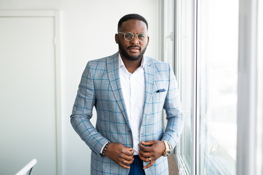 portrait of handsome african man in office wearing glasses 