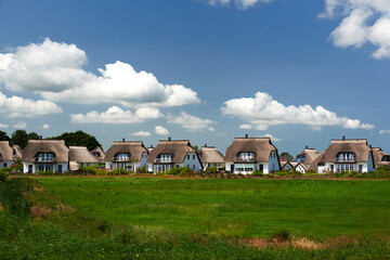 Fototapeta na wymiar Holiday complex with thatched roof houses on the island of usedom
