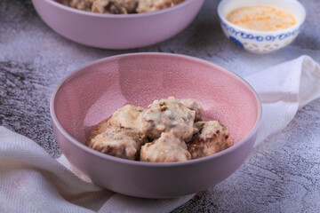 Homemade Swedish Meatballs coated in a gravy sauce served on a plate. 