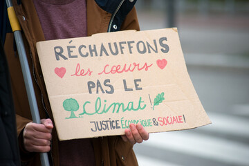 Mulhouse - France - 27 March 2021 - people protesting with banner in french : rechauffons nos coeurs, pas le climat , traduction in english : Let's warm our hearts not the climate - 423437647