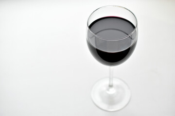 Large glass of red wine on a white background