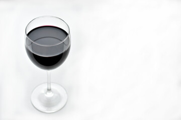 Large glass of red wine on a white background