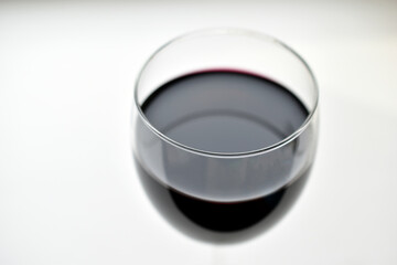 Large glass of red wine on a white background