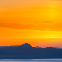 Fototapeta na wymiar sea cliff silhouette at the sunset