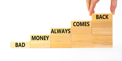 Business concept growth success process. Wood blocks stacking as step stair on white background, copy space. Businessman hand. Words 'bad money always comes back'. Conceptual image of motivation.