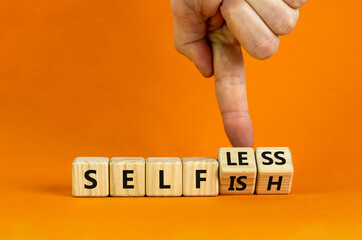 Selfish or selfless symbol. Businessman turns cubes and changes the word 'selfish' to 'selfless'....