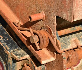 rusty metal spring coil pin on equipment trailer