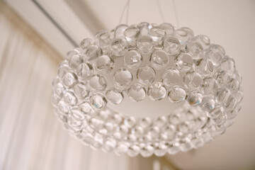 Stylish hi-tech chandelier made of transparent acrylic balls.