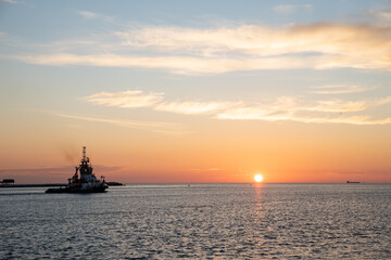 tugboat sailing on the sea at sunrise