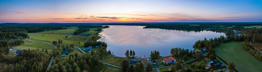 Aerial Scenic panorama of midnight Sun in Northern Sweden, middle summer light nights, polar...