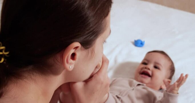 infant, childhood concept - close-up of smiling happy Baby plays with a teether. Teeth cutting. First teeth. Joy toothless 7 months baby bite, gnaws teether toy