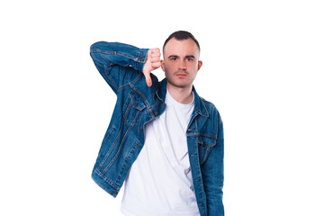 Photo of young man showing thumb down or dislike sign