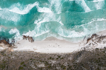 Scenic overhead view of turquoise sea waves and sandy beach