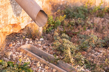 Obraz premium Storm sewer with grate. Drainage of rainwater into a storm ditch. How to make the drainage of the site and the drainage of water